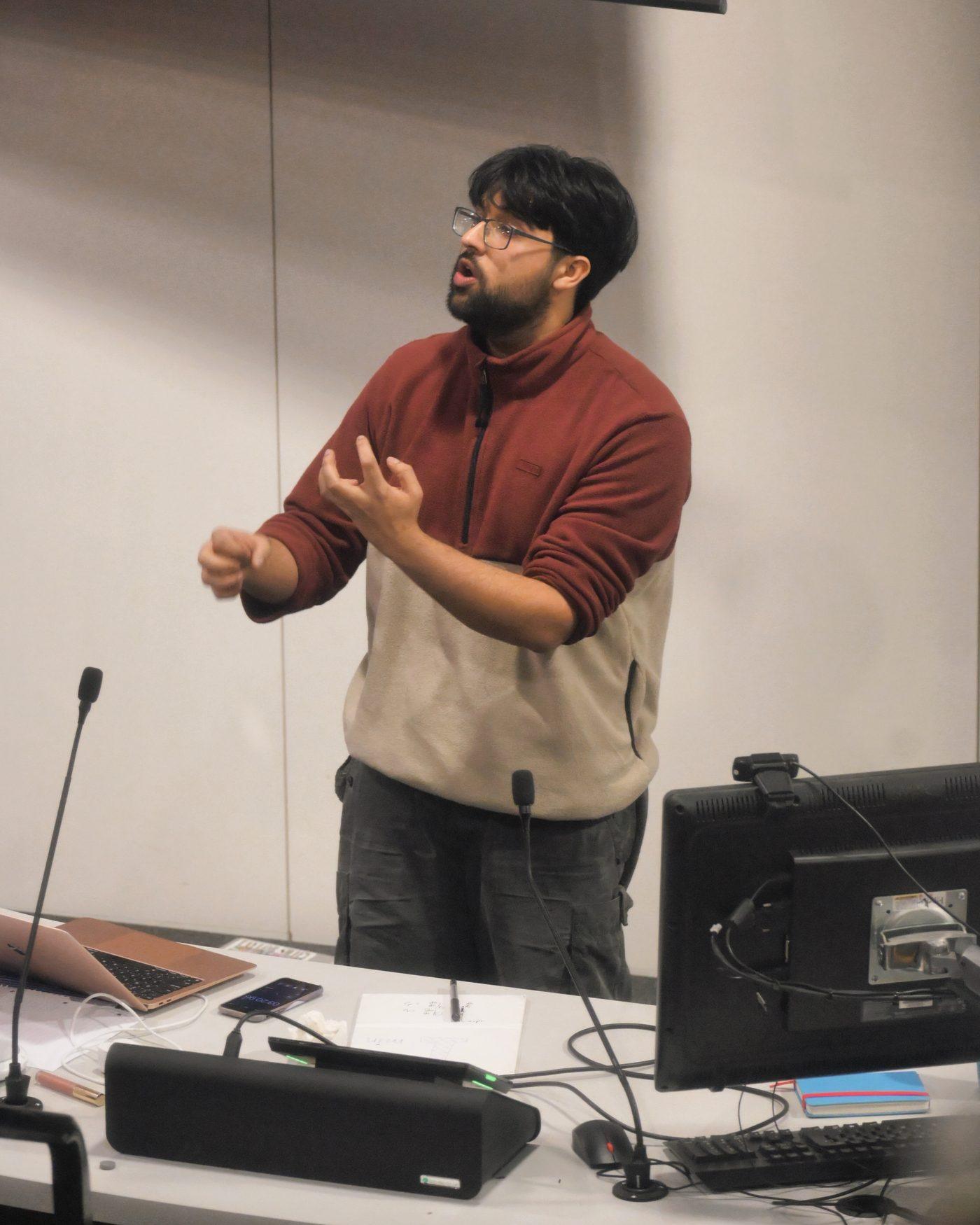 A member leading a training session at the front of a room